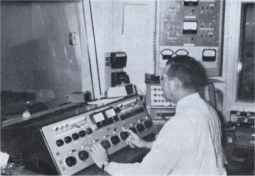 Arthur Stout in the Studio Control Room; transmitter remote equipment is at right.