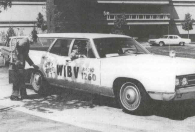 Late 1960's photo of Pete Maer at the wheel, Terry Gainey riding shotgun and SIU Edwardsville Professor Harry Thiel standing outside the WIBV News Scout. Note the broadcast antennae mounted on the left rear bumper for covering live events.